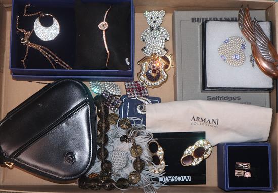 A group of assorted costume jewellery including Armani, Butler & Wilson and Swarovski.